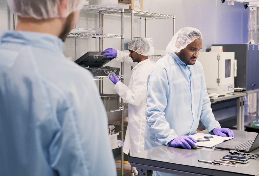 Various people working in a clean room